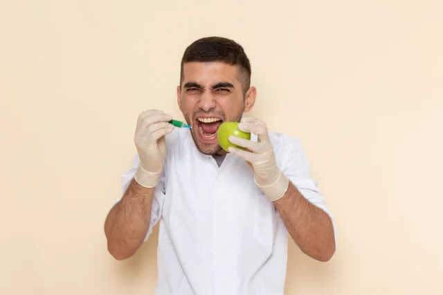 https://greenarbordental.com/wp-content/uploads/2024/12/front-view-young-male-white-suit-wearing-gloves-injecting-apple-screaming-beige-640x427.webp